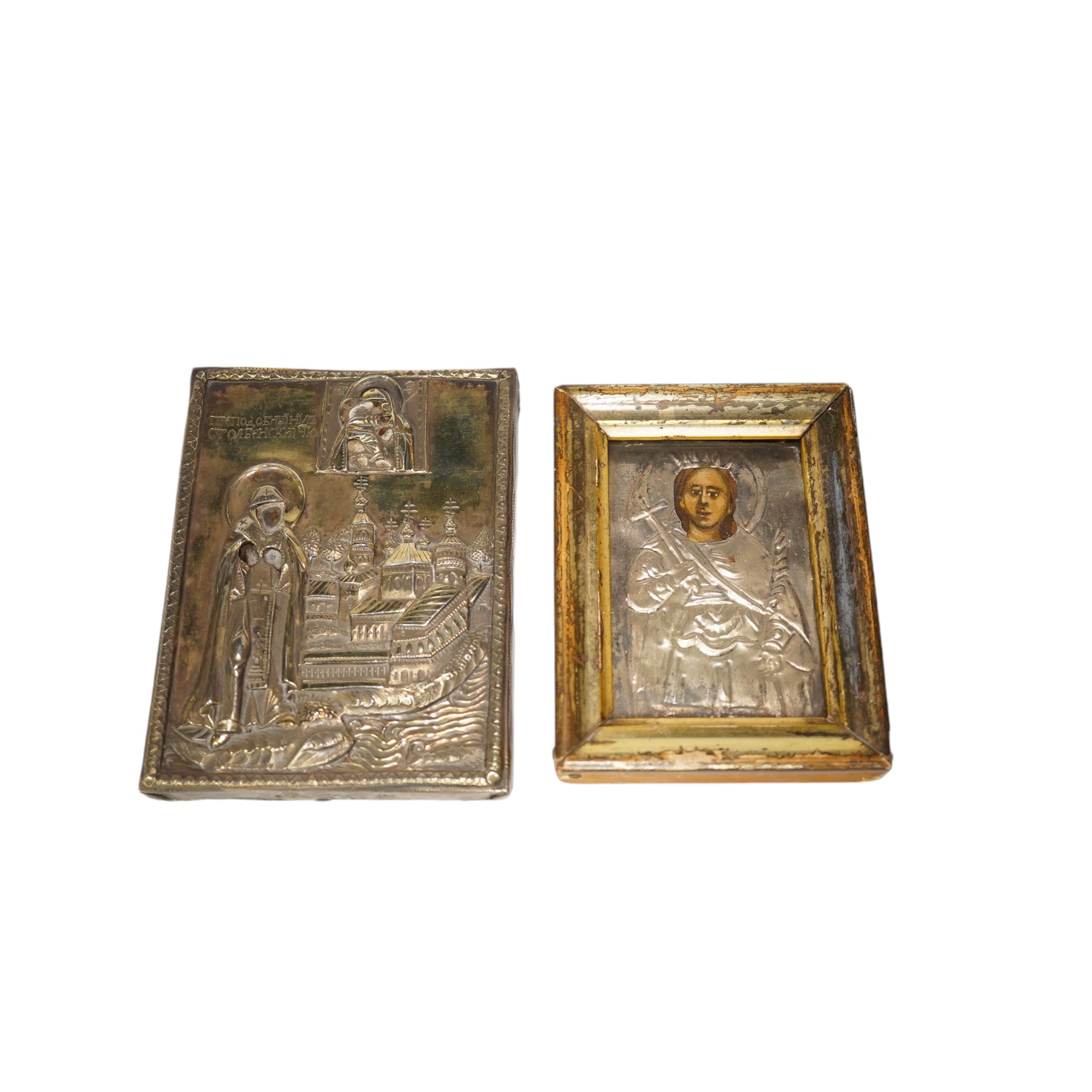An 18th/19th century Russian silver overlaid icon together with another, largest 12 x 9cm. Condition - fair